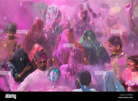 People Throwing Color Powder And Color Water Onto Each Other At Holi