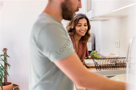 A Couples Chore Sharing Bringing Happiness To A Woman Watching Her Partner Wash Dishes Photo