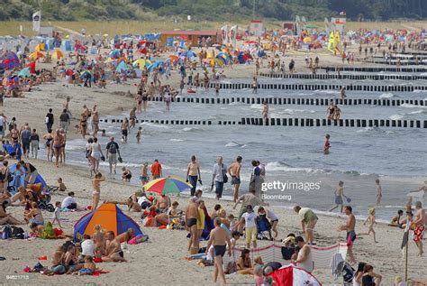 Beachgoers Enjoy The Sun And Surf At Warnemuende Beach In Rostock