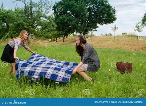 Two Girls Spreading A Blanket For Picnic Stock Image Image Of Holiday Blue 57458491