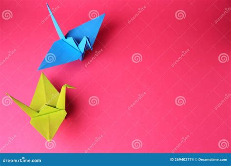 Origami Art Colorful Handmade Paper Cranes On Pink Background Above