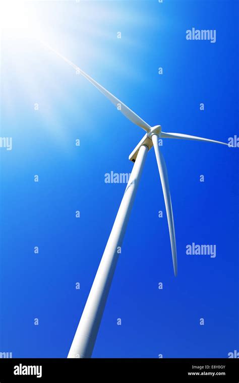 Wind Turbine Under Clear Blue Sky Stock Photo Alamy