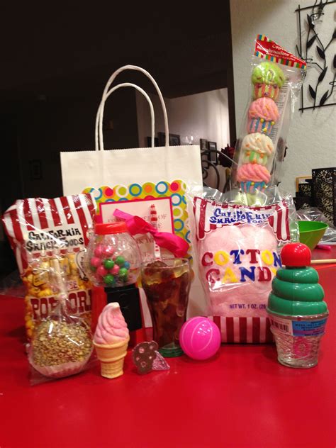 candy and candies are sitting on the counter in front of bags cups and other items