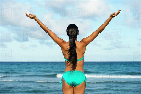 Hispanic Woman Wearing Bikini On Beach Stock Photo Dissolve