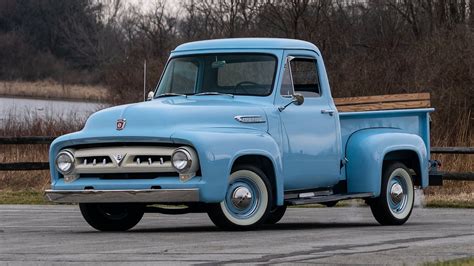 An Old Blue Truck Is Parked On The Road