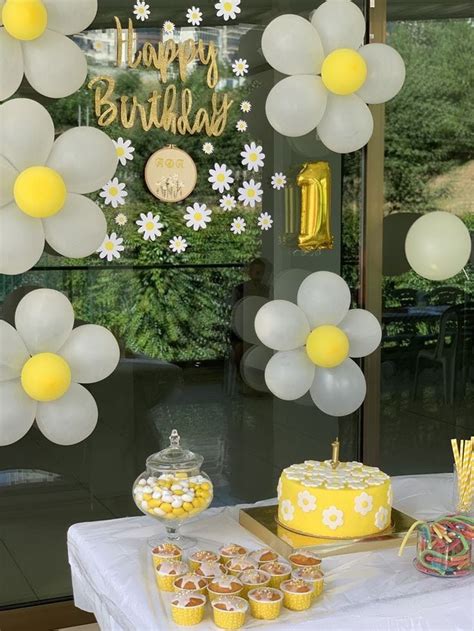 A Table Topped With Cake And Cupcakes Covered In Frosting Next To Balloons