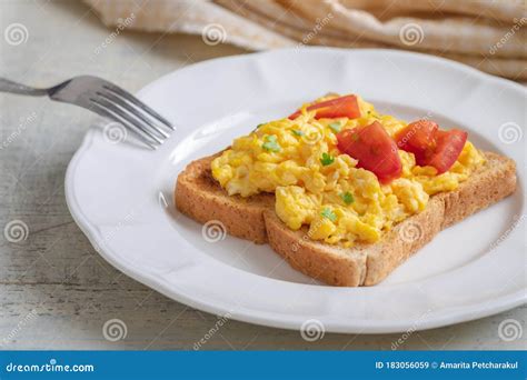 Scrambled Eggs With Tomato On Toasted Whole Wheat Bread Stock Image