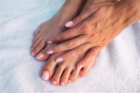 Beautiful Woman Hands And Feet With French Manicure And Pedicure On A