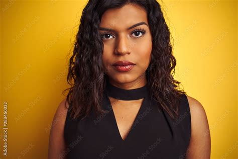 Transsexual Transgender Woman Wearing Black T Shirt Over Isolated Yellow Background With A