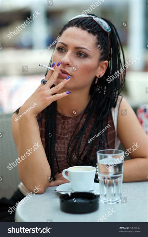 photo de stock woman smoking cigarette outiside coffee bar 79676533 shutterstock