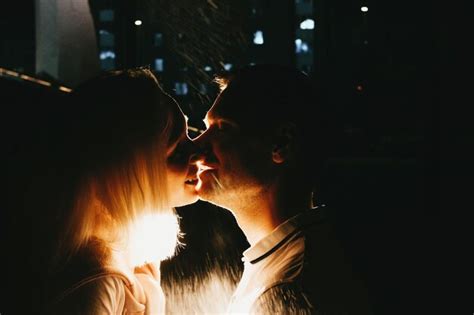 premium photo couple kissing while at night