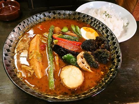 Soup curry (スープカレー) is a light curry flavored soup served with some type of meat, and a rainbow of roasted vegetables. SOUP CURRY＆HAMBURG 龍祈 TATSUKI | 札幌スープカレーブログ