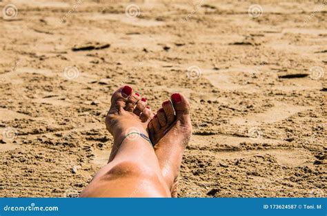 Woman Feet In The Sand With Red Painted Nails Stock Image Image Of