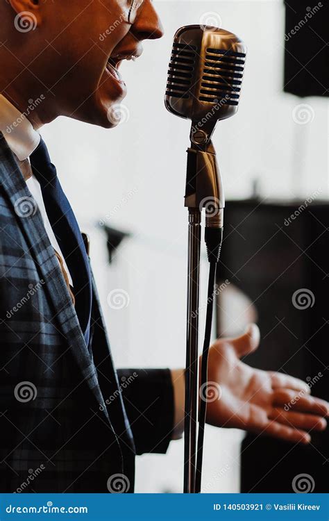 Retro Fifties Singer With Vintage Microphone And Sunglasses Studio