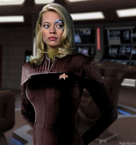 A Woman In A Star Trek Uniform Is Standing With Her Hands On Her Hips