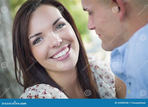 Smiling Mixed Race Romantic Couple Portrait In The Park Stock Photo