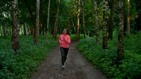 Two Young Women Jogging On The Forest Track Slow Motion Stock Footage