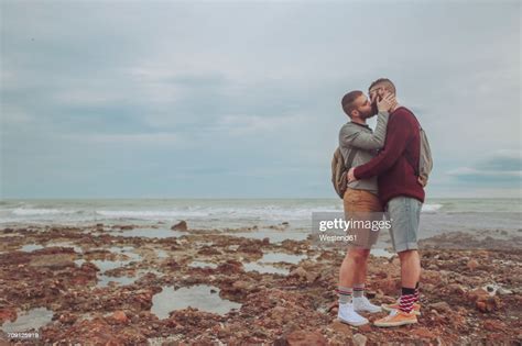 Young Gay Couple Kissing On The Beach Photo Getty Images