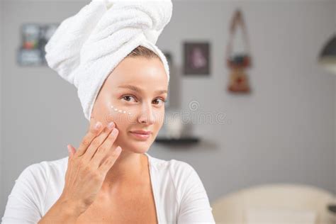 Happy Young Woman Applying Cream To Her Face Woman Face Skin Care