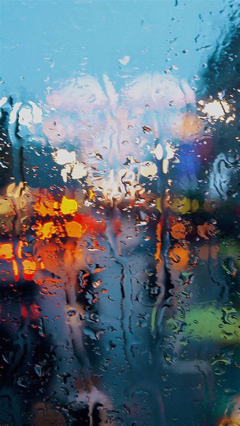 Download A Peaceful View Rain Falling Softly Outside A Window