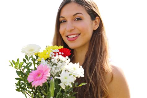 outdoor portrait of a joyful and romantic woman smiling with a bouquet of flowers green latin