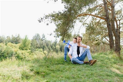 father and son have fun together in nature father and son playing people having fun outdoors