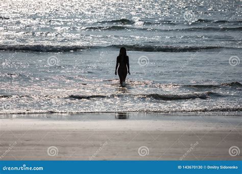 Silhouette Of A Naked Girl Coming Out Of The Sea Stock Photo Image Of