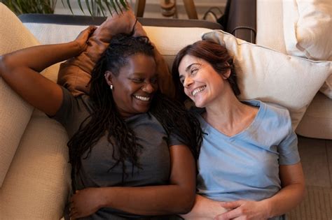 Free Photo Top View Lesbian Couple Laying On Couch