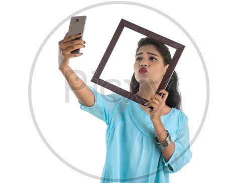 Image Of Pretty Young Indian Girl Taking Selfie Using Photo Fames In