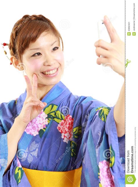 Japanese Woman Wearing Kimono Takes A Picture Of Herself Stock Image