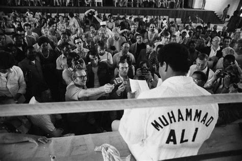 Muhammad Ali Sitting On The Side Of Muhammad Ali Enterprises