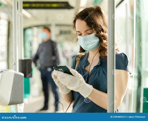 Female In Disposable Mask With Phone In Streetcar Stock Photo Image