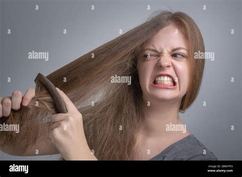 Young Caucasian Woman Girl Struggling To Comb Brush Her Straight Hair