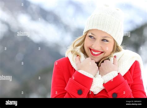 Candid Woman In Red Keeping Warm And Looking At Side In Winter Holiday