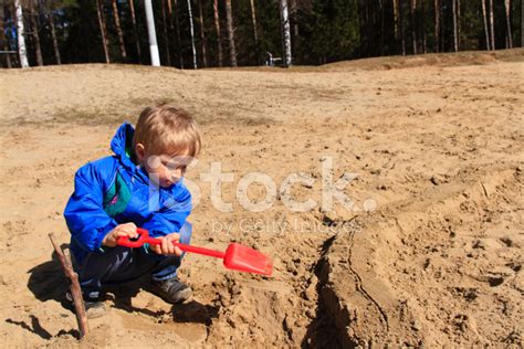 Little Boy Digging Sand In Spring Stock Photos