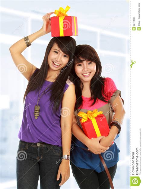 Two Young Girls Carrying Present Stock Image Image Of Cheerful