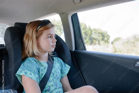 Little Girl Seating On The Back Seat Of A Car Stock Photo Adobe Stock