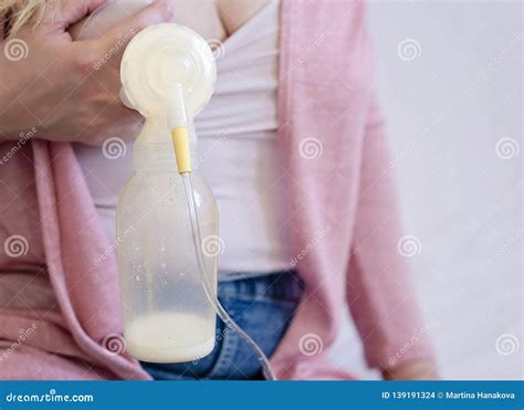 Young Mother Is Using Single Electric Breast Milk Pump And Pumping