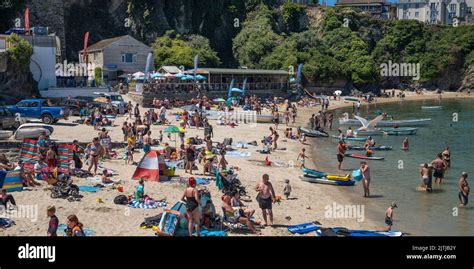 A Panoramic Image Of Holidaymakers Crowded On The Small Beach In The Picturesque Newquay Harbour