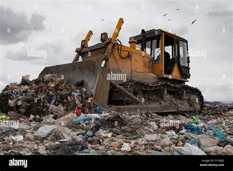 Bulldozer Working On Mountain Of Garbage In Landfill Stock Photo Alamy