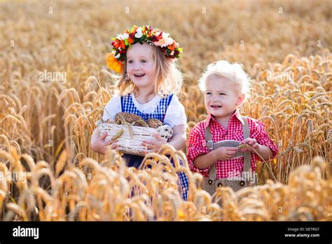 Kids In Traditional Bavarian Costumes In Wheat Field German Children