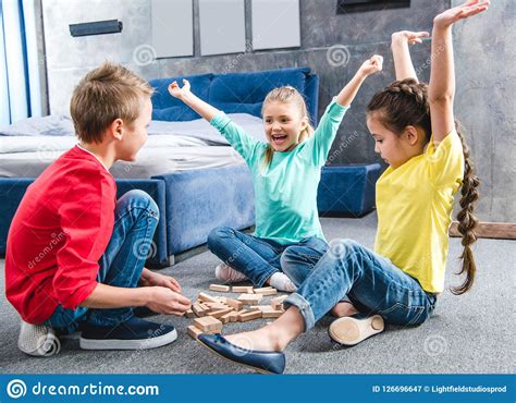 Happy Children Sitting On Carpet And Playing Stock Image Image Of