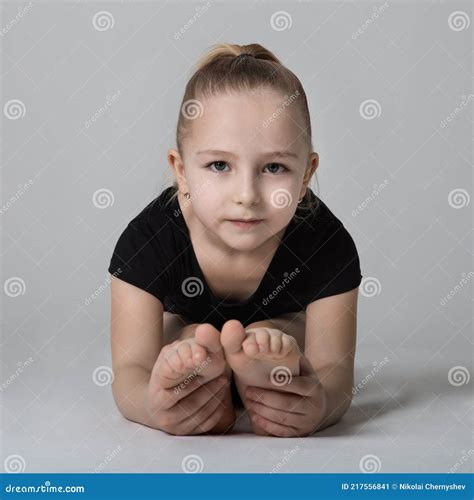 girl gymnast doing bends to the legs looking easily at the camera stock image image of