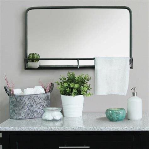 An Industrial Bathroom Mirror With A Built In Shelf To Help Keep Your