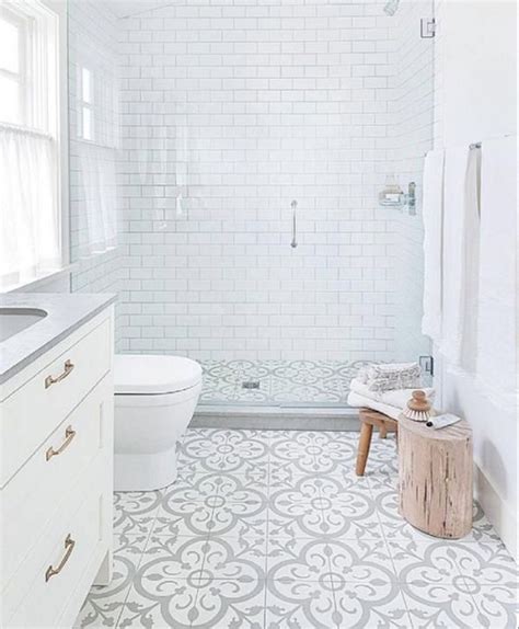 A Bathroom With White And Gray Tiles On The Floor