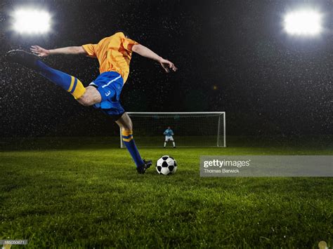 professional soccer player about to strike penalty kick goalkeeper in soccer penalty kick
