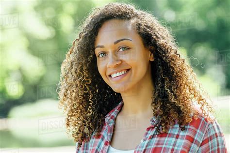Portrait Of Smiling Mixed Race Woman Outdoors Stock Photo Dissolve