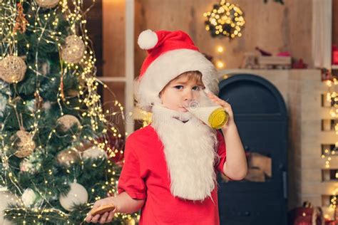 Santa Claus Enjoys Cookies And Milk Left Out For Him On Christmas Eve Portrait Of Surprised And