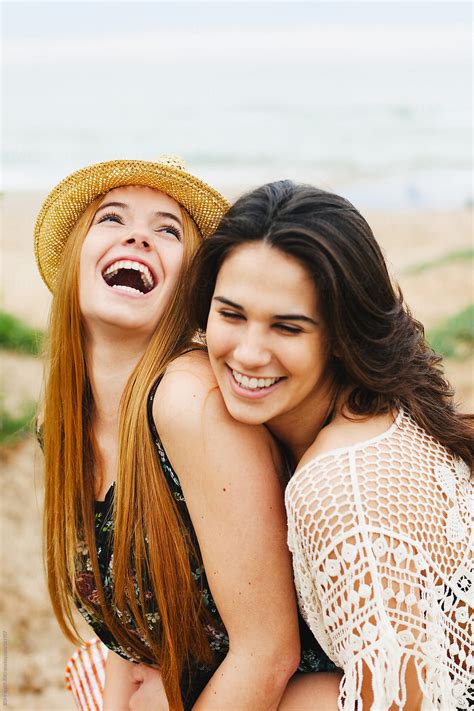 Portrait Of Two Young Female Friends Having Fun On The Beach Del