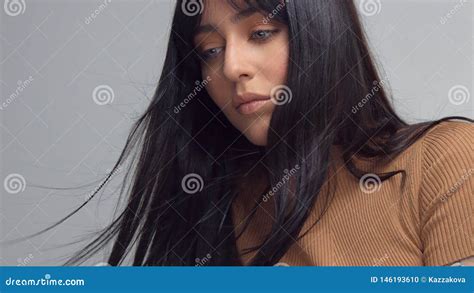 Mixed Race Brunette Woman With Blue Eyes In Studio Stock Photo Image